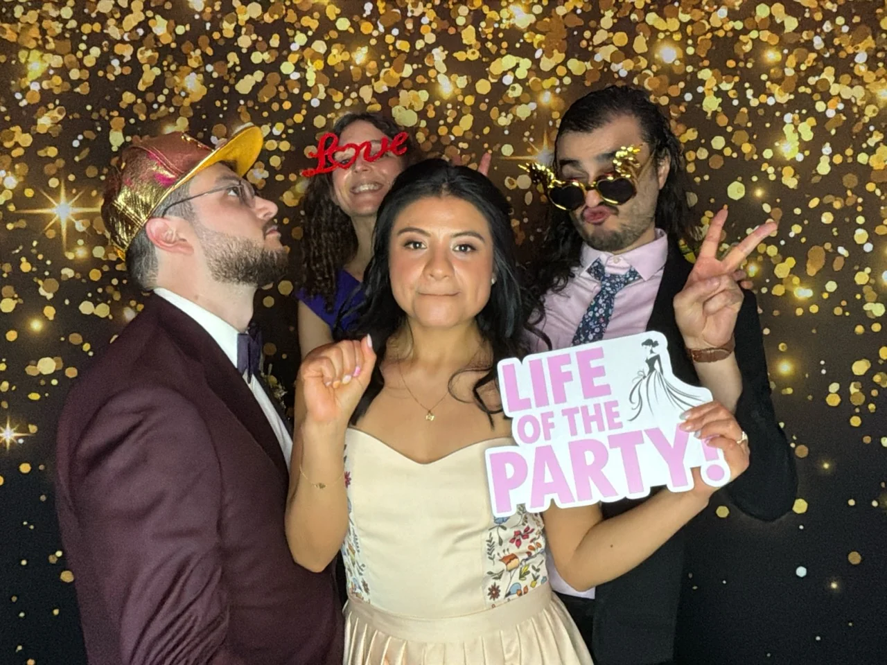Bride and guests pose with party props at a Coral Gables wedding reception