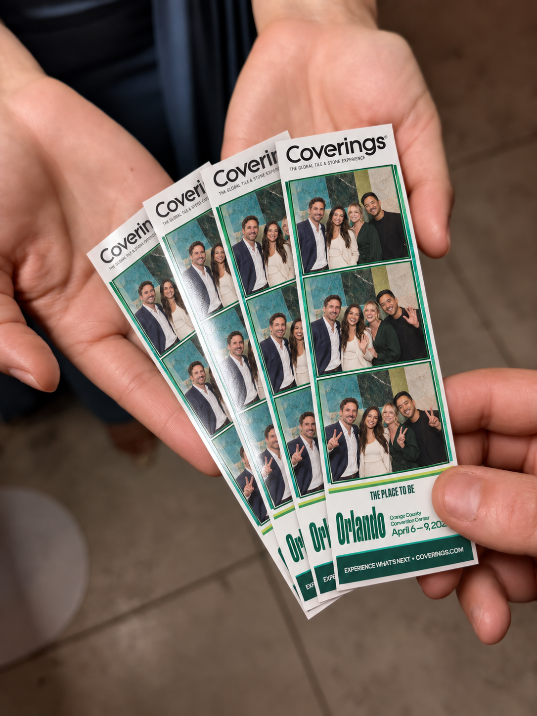 Hands holding Coverings 2027 branded photo strips, shown as a promotional design concept