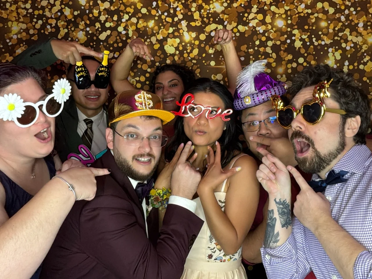 Newlyweds and friends crowd into the Digital Photo Booth at a Coral Gables wedding