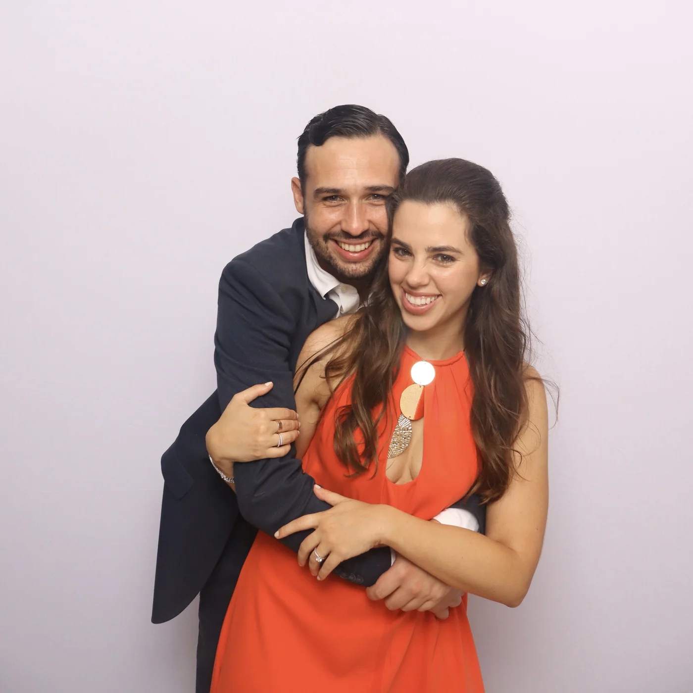 Smiling couple posing together in a colorful DSLR photo booth portrait