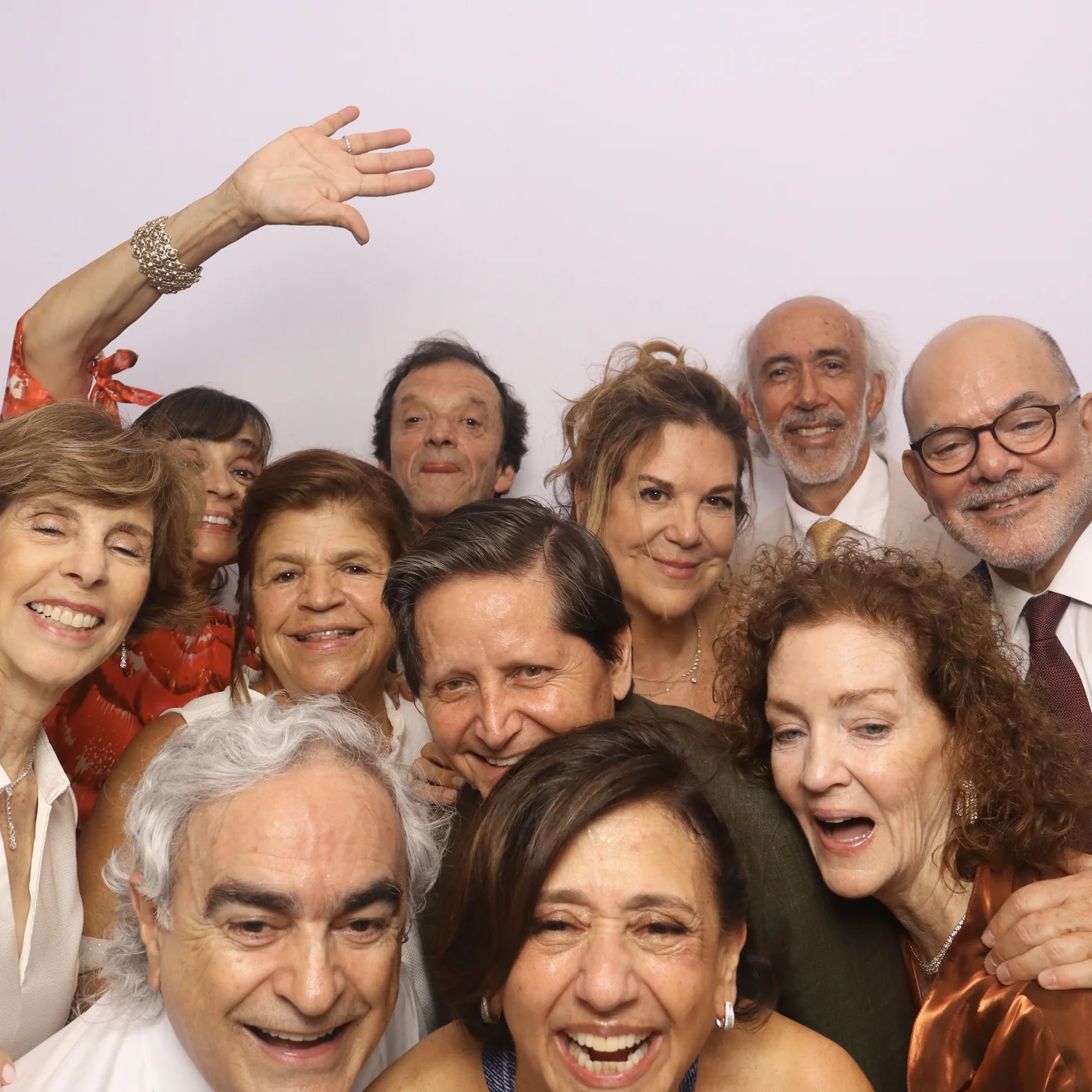 Large group of wedding guests crowding into a colorful DSLR photo booth portrait