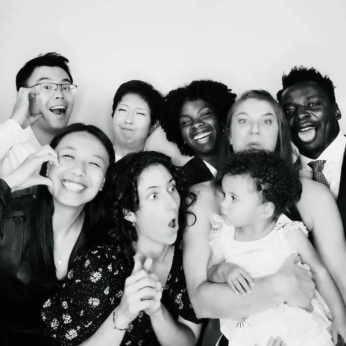 Family together in a black-and-white Glam booth photo