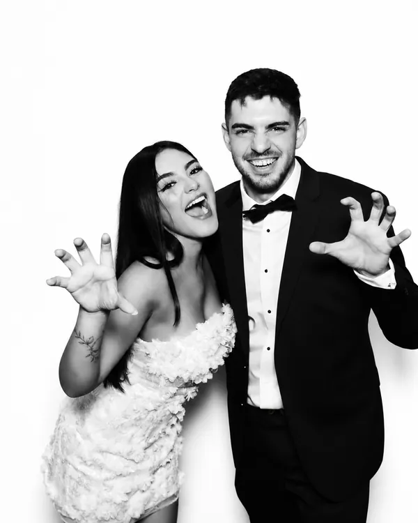 Bride and groom posing for polished black-and-white Glam Booth portraits