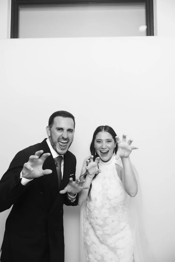 Bride and groom posing at the Glam photo booth during a wedding at Key Biscayne Yacht Club