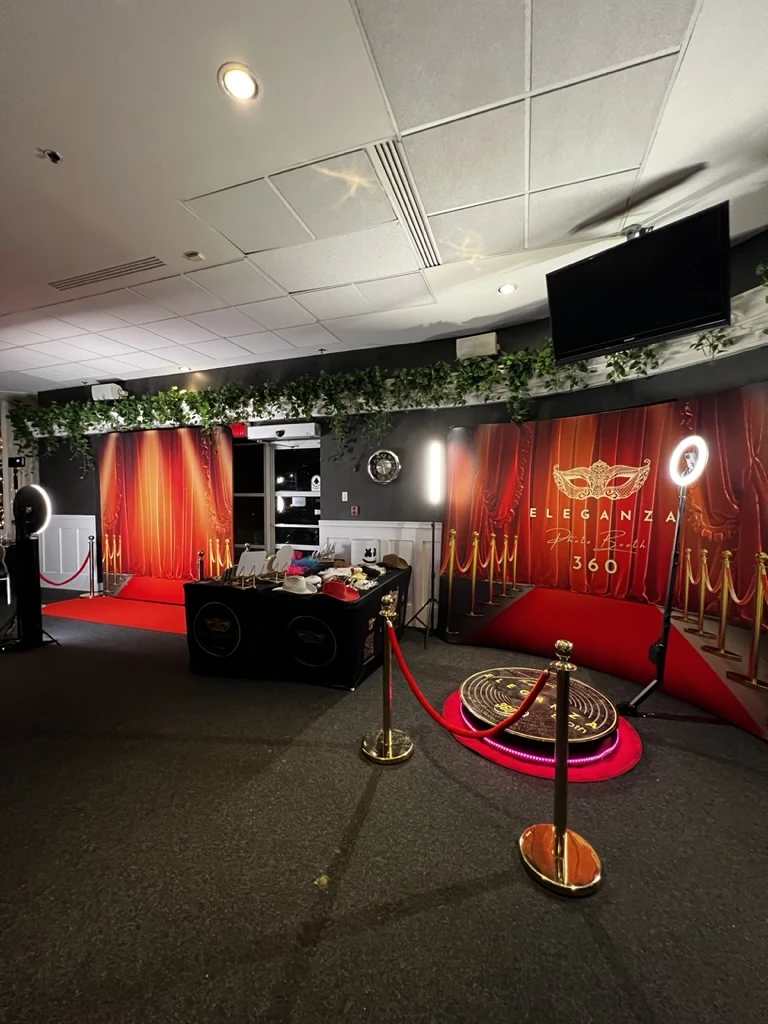 Eleganza photo booth setup with red carpet, gold stanchions and the 360 platform at a Miami venue