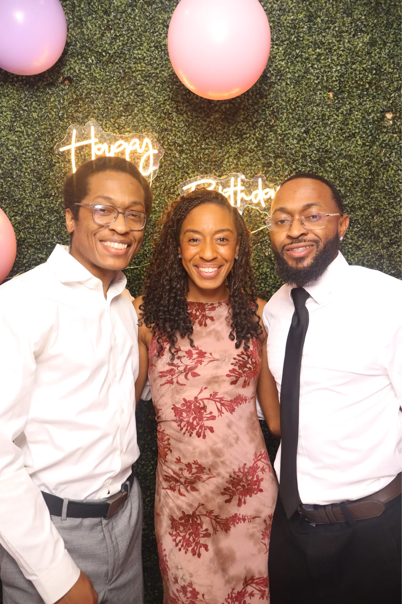 Three guests pose together at a birthday photo booth in Sunrise, Florida
